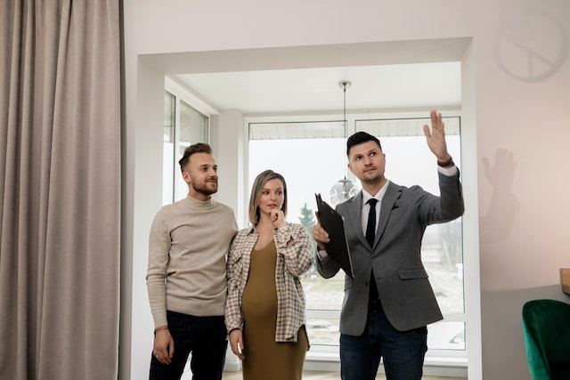 Real estate agent showing a couple around a rental home